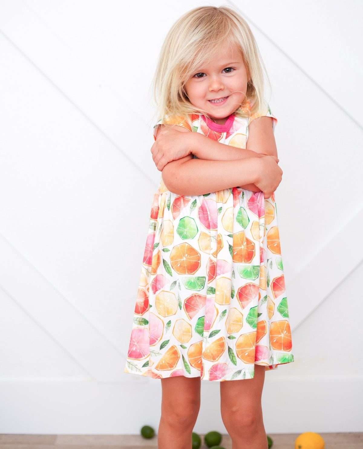 Short-sleeve baby dress with a colorful citrus fruit print in a twirl-ready skirt shape