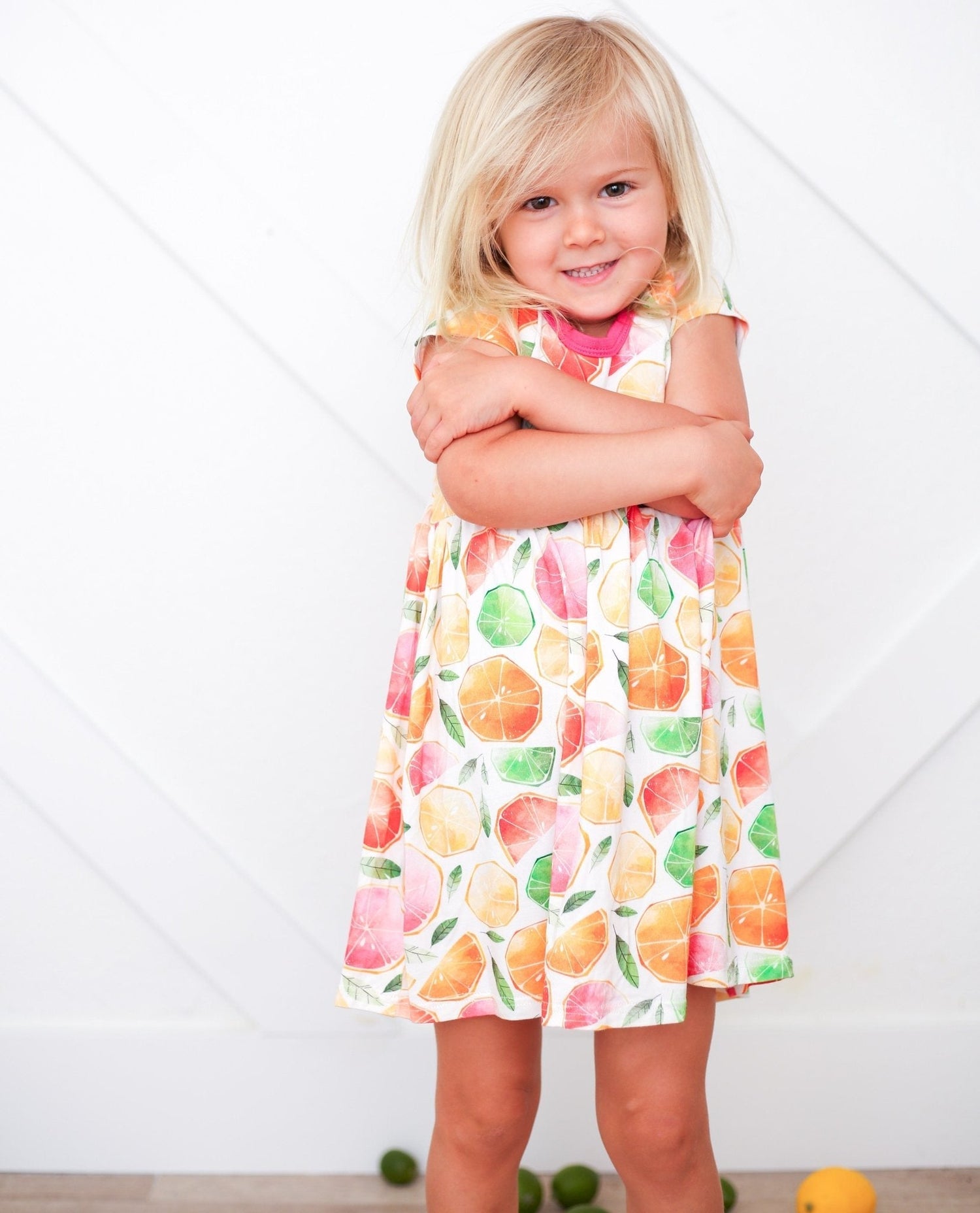 Short-sleeve baby dress with a colorful citrus fruit print in a twirl-ready skirt shape