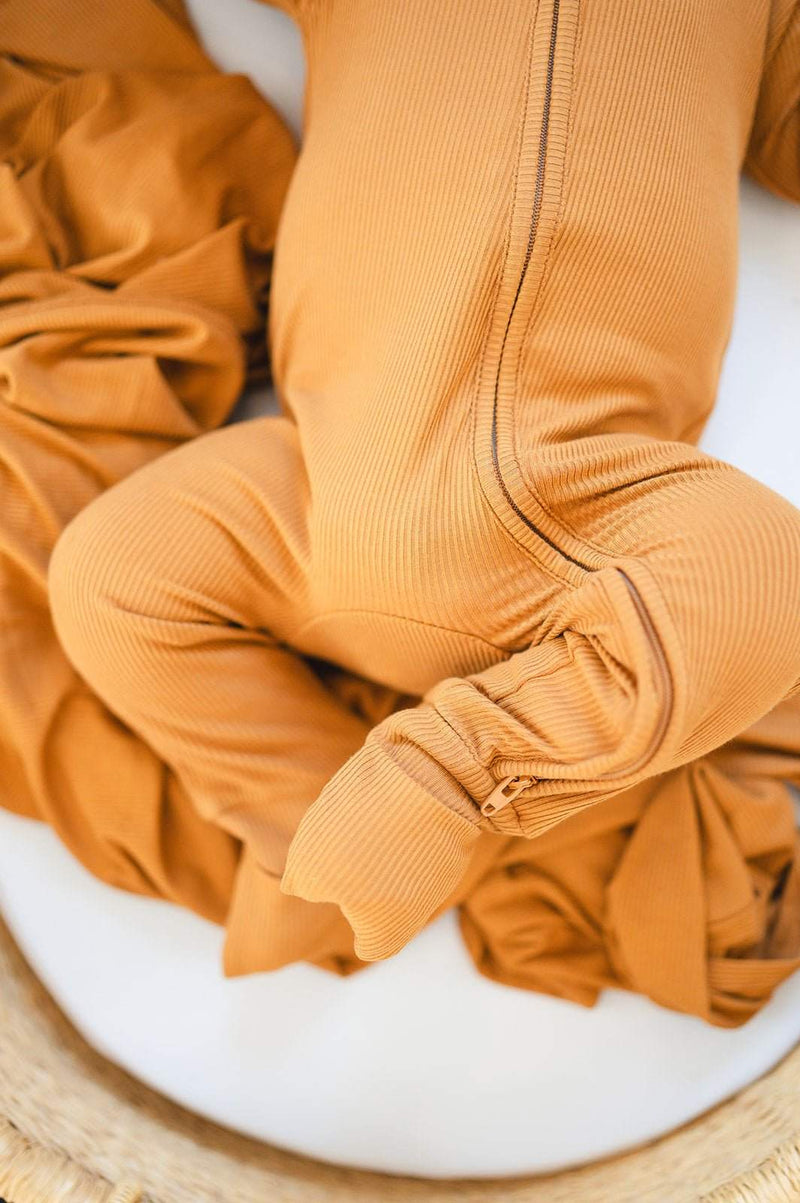 Caramel ribbed zipper romper with fold-over feet and hands for babies.