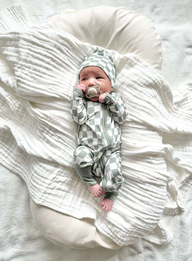 Zipper Romper in jade checker pattern on baby, featuring bamboo viscose fabric and fold-over cuffs.