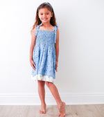 Blue floral baby dress with smocked top, tie straps, and a layered skirt